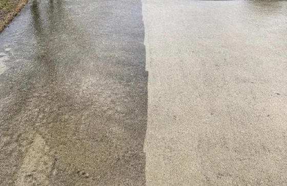 A driveway, half pressure-washed